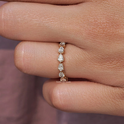 Pear-shaped lab-grown diamond eternity band ring detail on fingertip