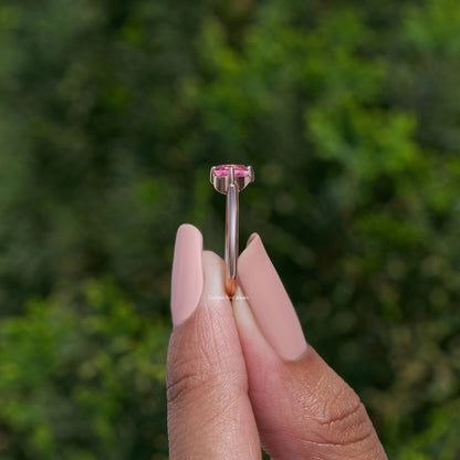 Toi et moi ring featuring two pink pear-cut lab gemstones in raised prong settings