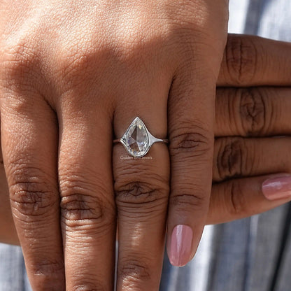 Close-Up View of Pear Cut Bezel Set Moissanite Ring In White Gold       