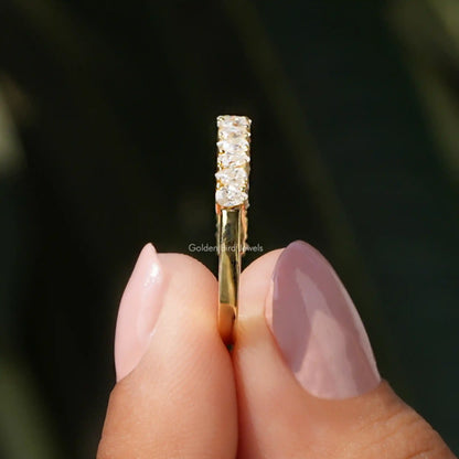 Side view of half-eternity moissanite ring with stacked prong-set stones