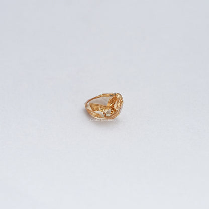 Pear-cut moissanite loose stone, warm golden color, angled top view