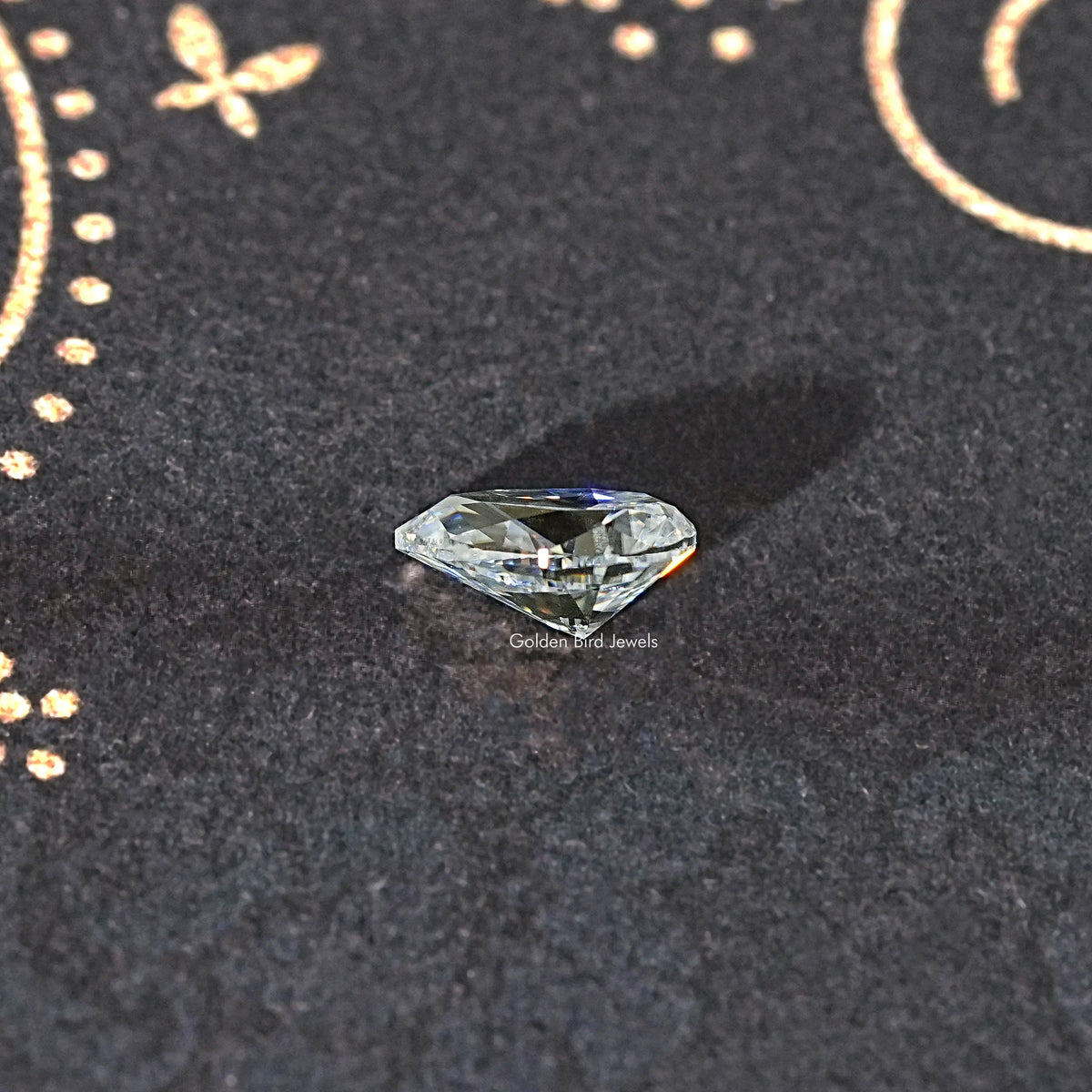 Pear-cut colorless moissanite loose stone with crisp facet reflections.