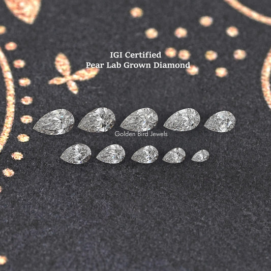 Multiple pear-shaped lab-grown diamonds arranged on dark velvet