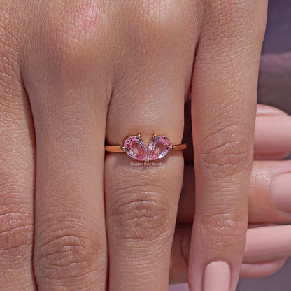 Pink pear-cut lab gemstone toi et moi ring with two prong-set stones on slim band