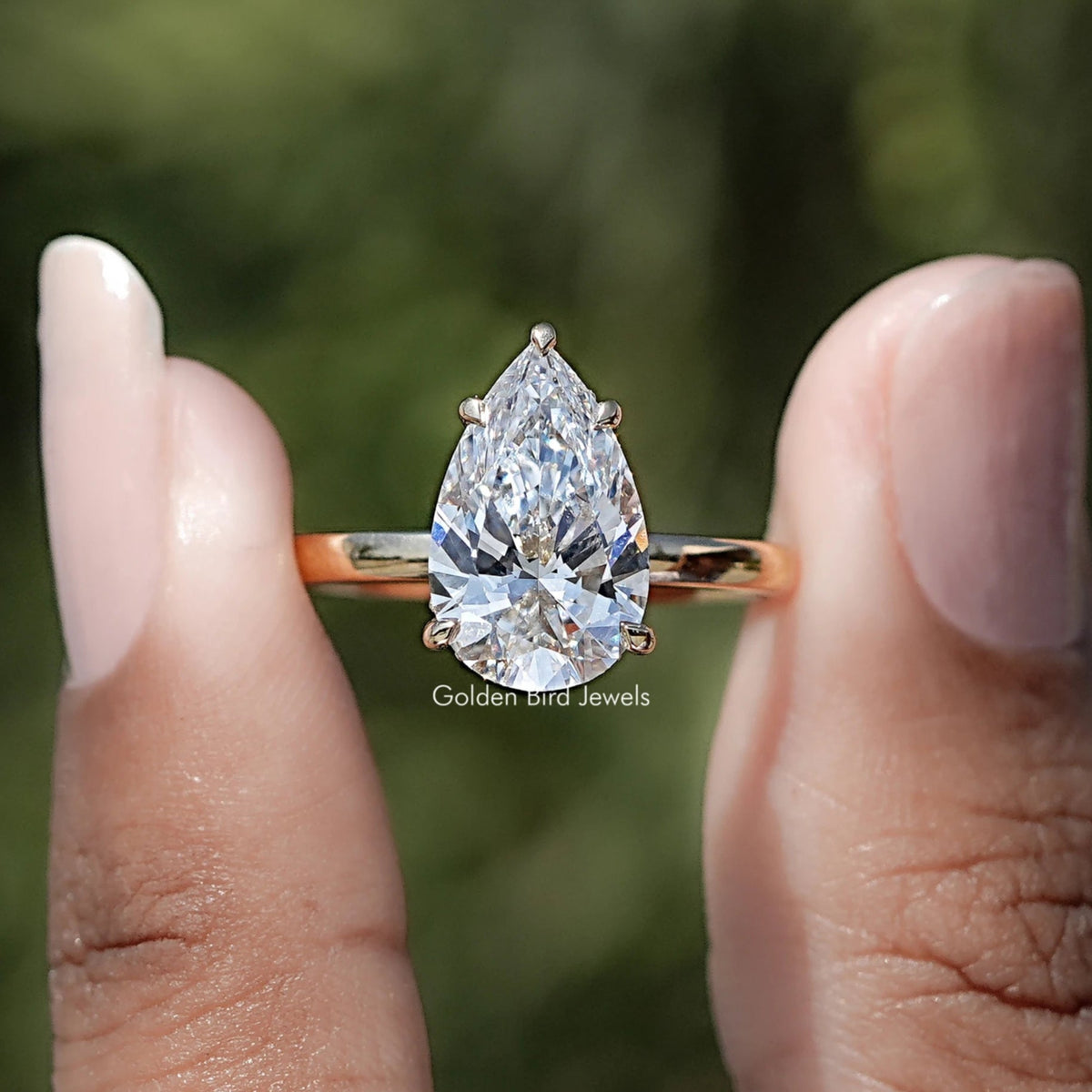 Pear Shaped Lab Diamond Hidden Halo Ring Between Two Fingers