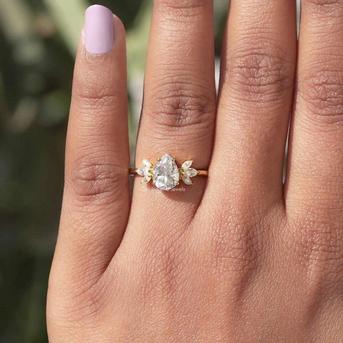 Close-Up View of Pear Shaped Moissanite Ring In Yellow Gold