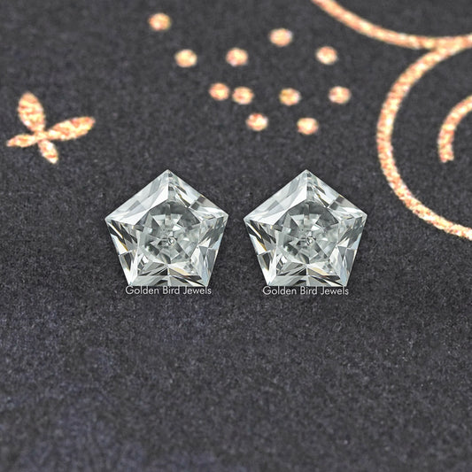 Pentagon-cut lab-grown diamond pair, two clear faceted stones side by side