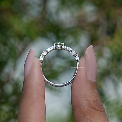Back View of Peridot Green Oval Cut Engagement Ring In two fingers