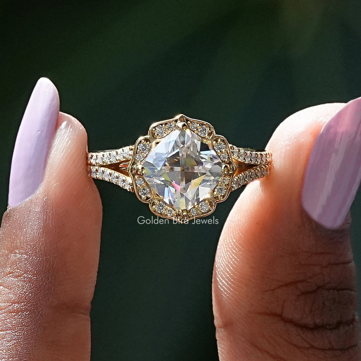 Two fingers holding the Peruzzi Cut Moissanite Halo Split Shank Ring