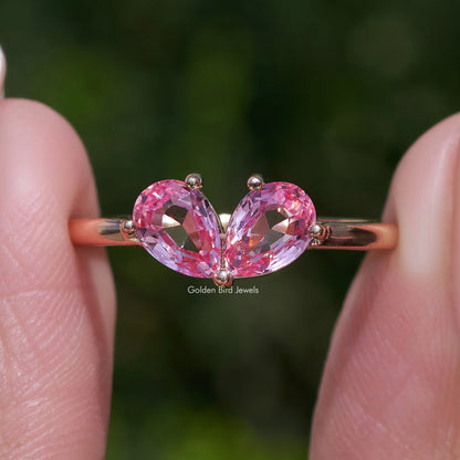 Toi et moi ring with two pink pear-cut lab gemstones, heart-like center prong set