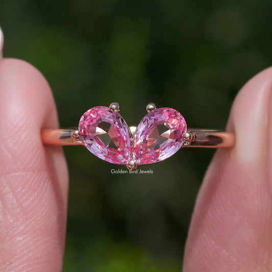Toi et moi ring with two pink pear-cut lab gemstones, heart-like center prong set