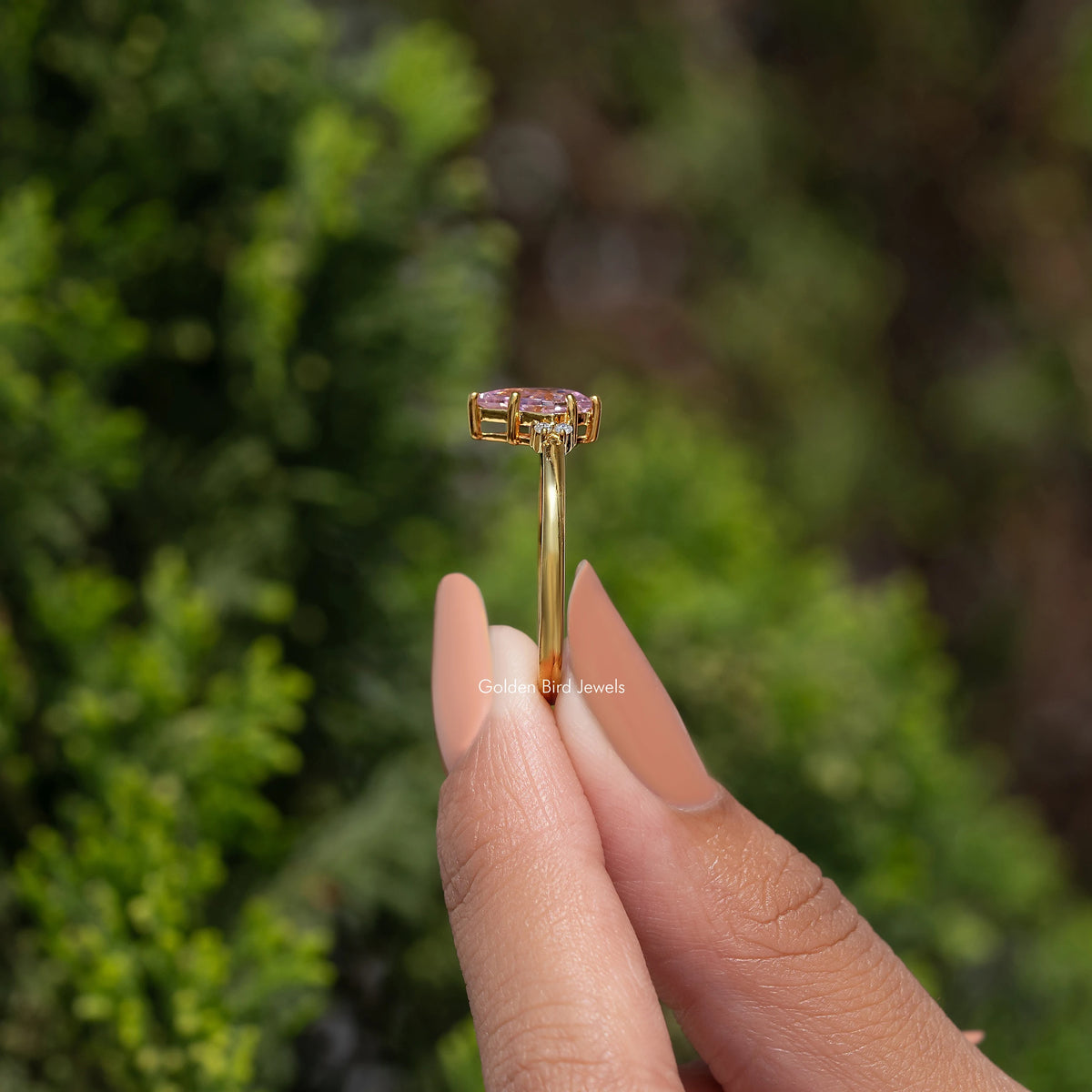 Gold engagement ring with pink square-cut kite gemstone on slender band