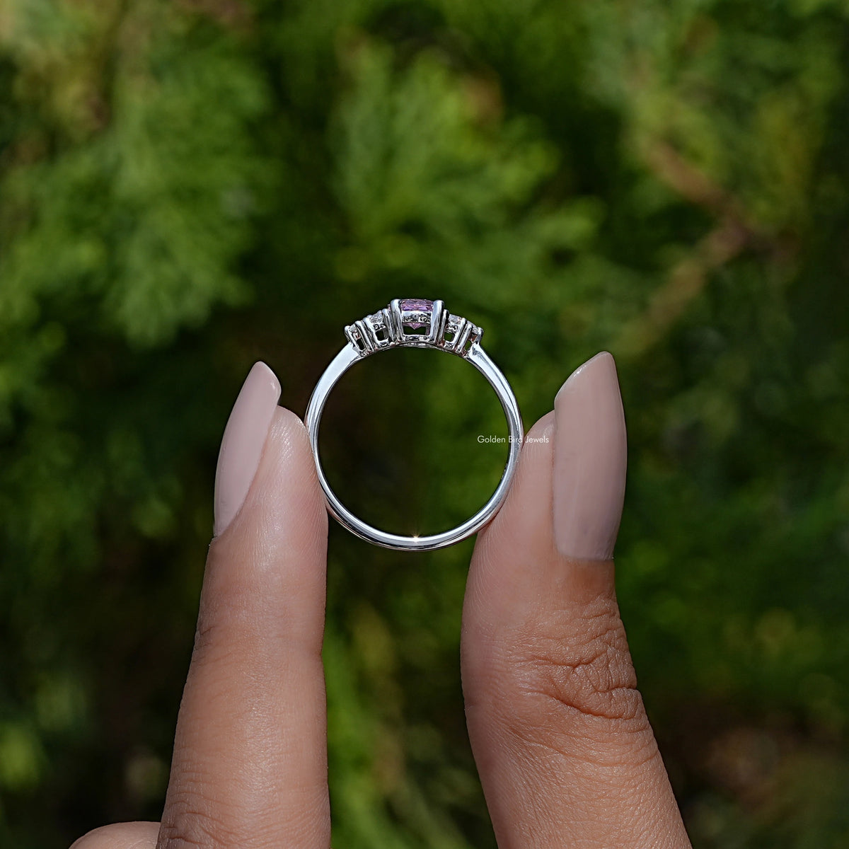 Oval gemstone engagement ring with prong-set center and polished silver band