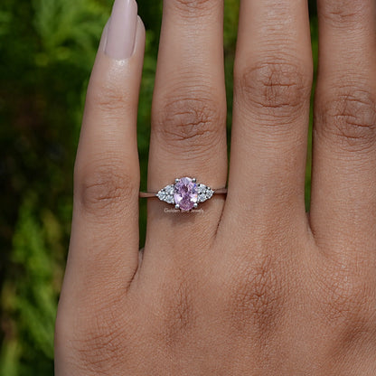 Silver engagement ring with oval pink center stone and round side stones