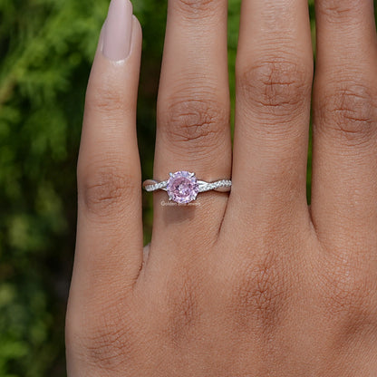 Pink round gemstone accent ring with sterling band and glittering side stones