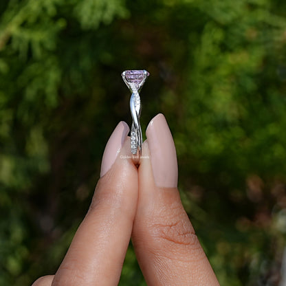 Sterling silver ring with oval prongs holding a pink round gemstone