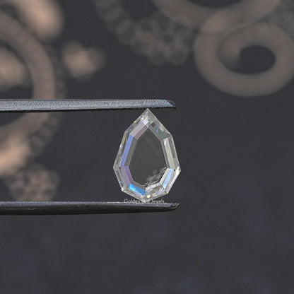 Faceted clear moissanite loose gemstone held between metal tweezers, step-cut.