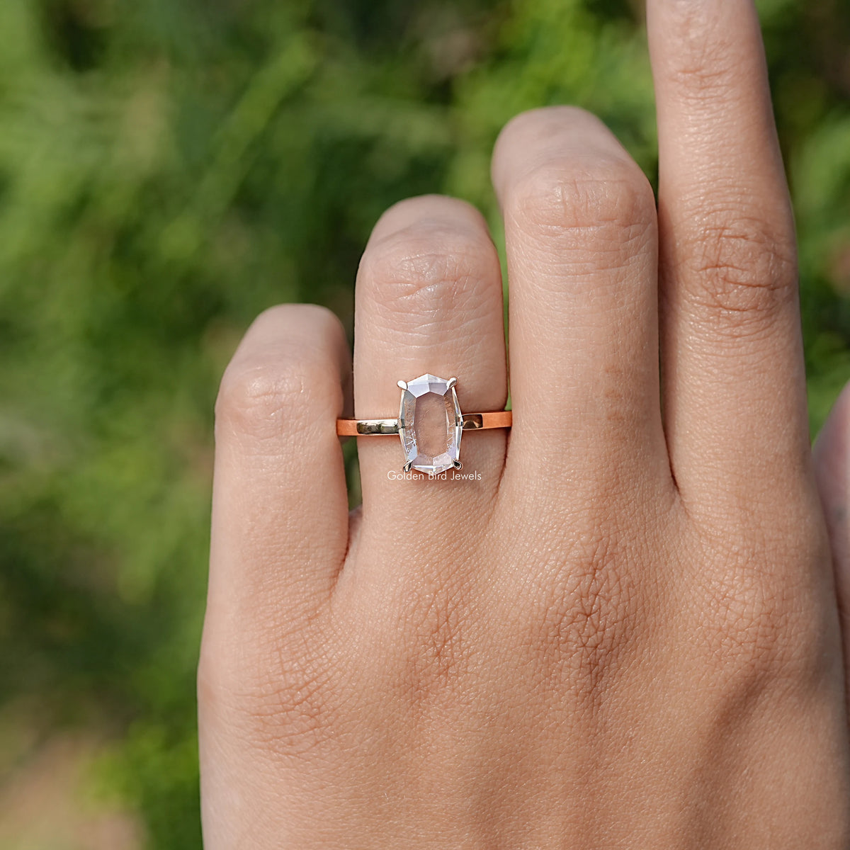In finger front view of Portrait Cut Hexagon Moissanite Ring