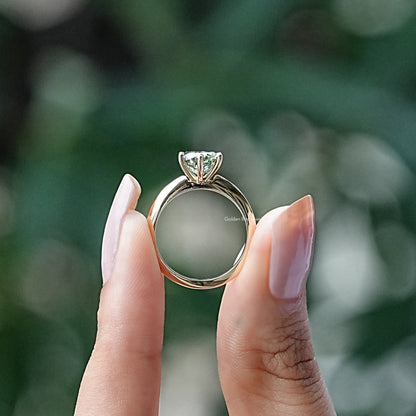 Back View of Round Cut Moissanite Solitaire Ring In two fingers