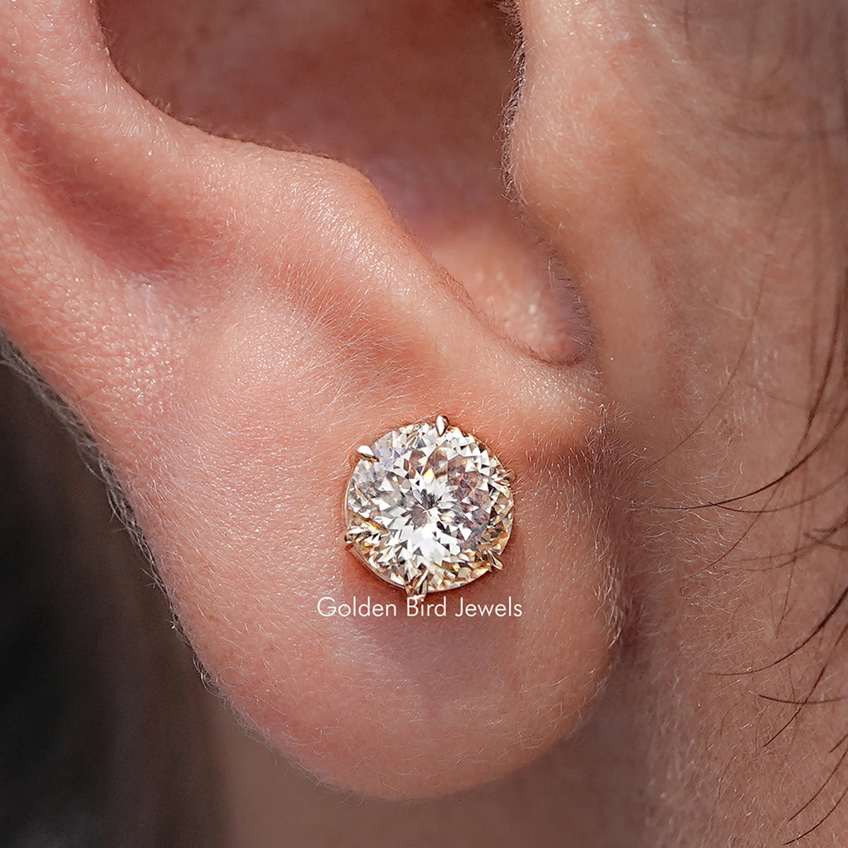 In Ear View Of Portuguese Round Cut Moissanite Stud Earrings in prongs setting                                                         		
