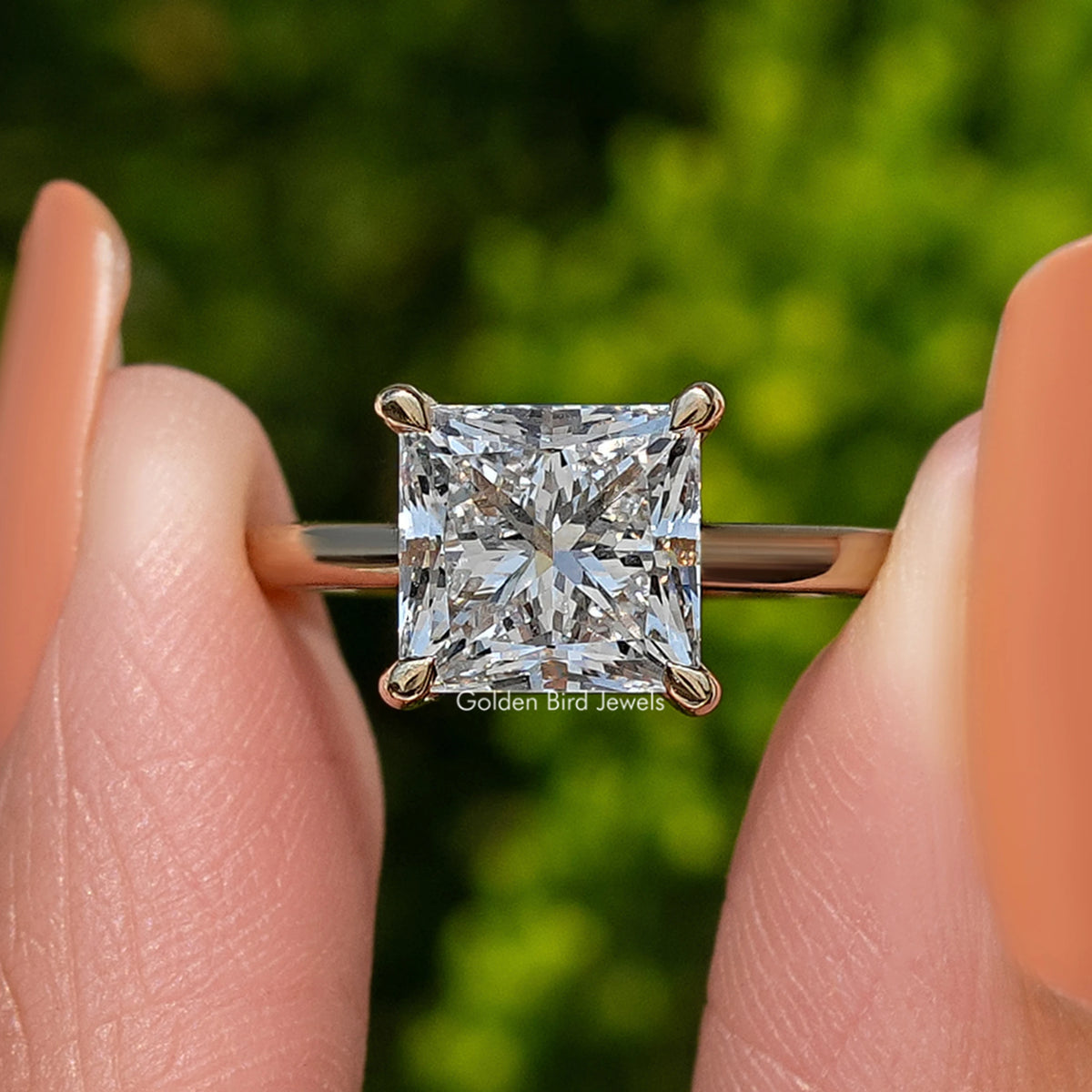 Princess-cut diamond solitaire ring, front view showing stone facets and prongs