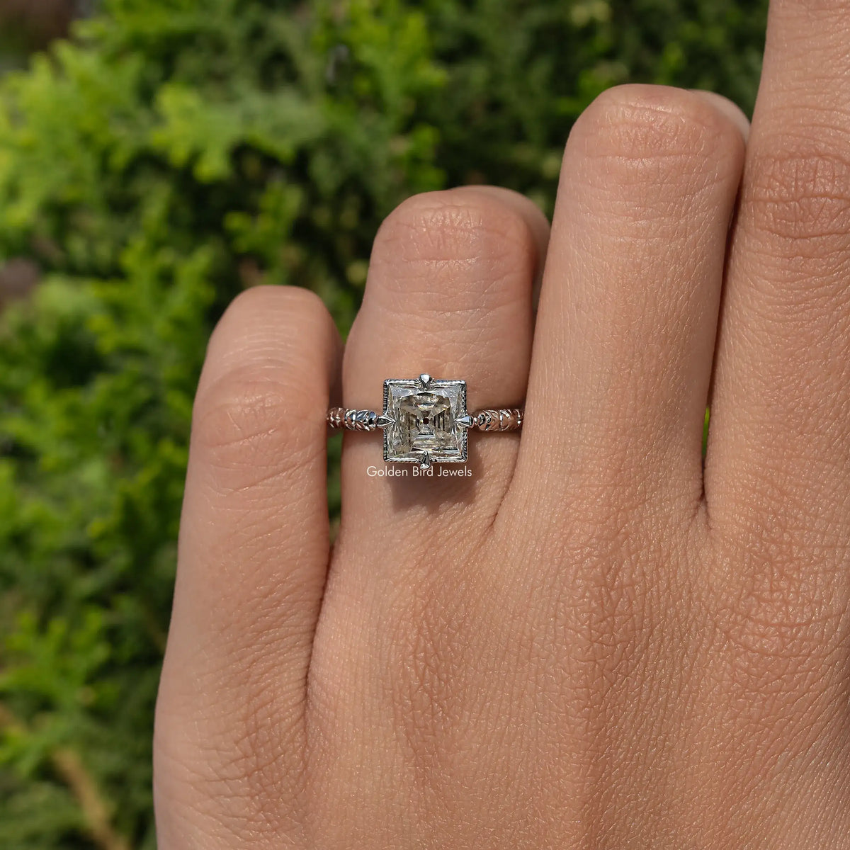 Sterling silver princess-cut moissanite solitaire ring with ornate side shoulders