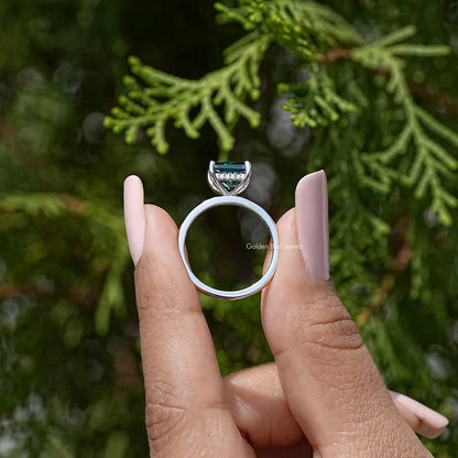 925 sterling silver wedding ring showing open hidden halo setting around emerald-green stone
