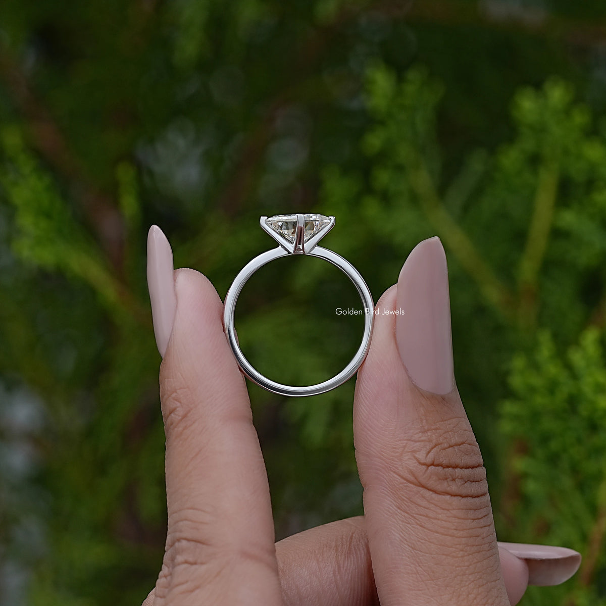 Princess-cut solitaire engagement ring back view on hands, slim silver band and center stone
