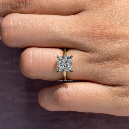 Princess-cut diamond solitaire ring close-up on center stone and prongs