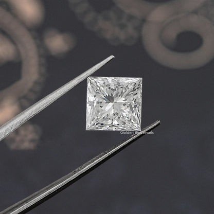 Close-up of a princess-cut lab-grown diamond between tweezers