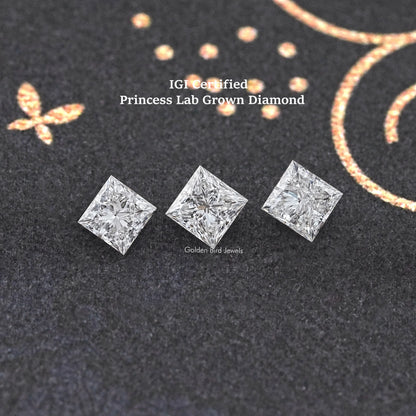 Three princess-cut lab-grown diamonds on dark felt, three-stone arrangement