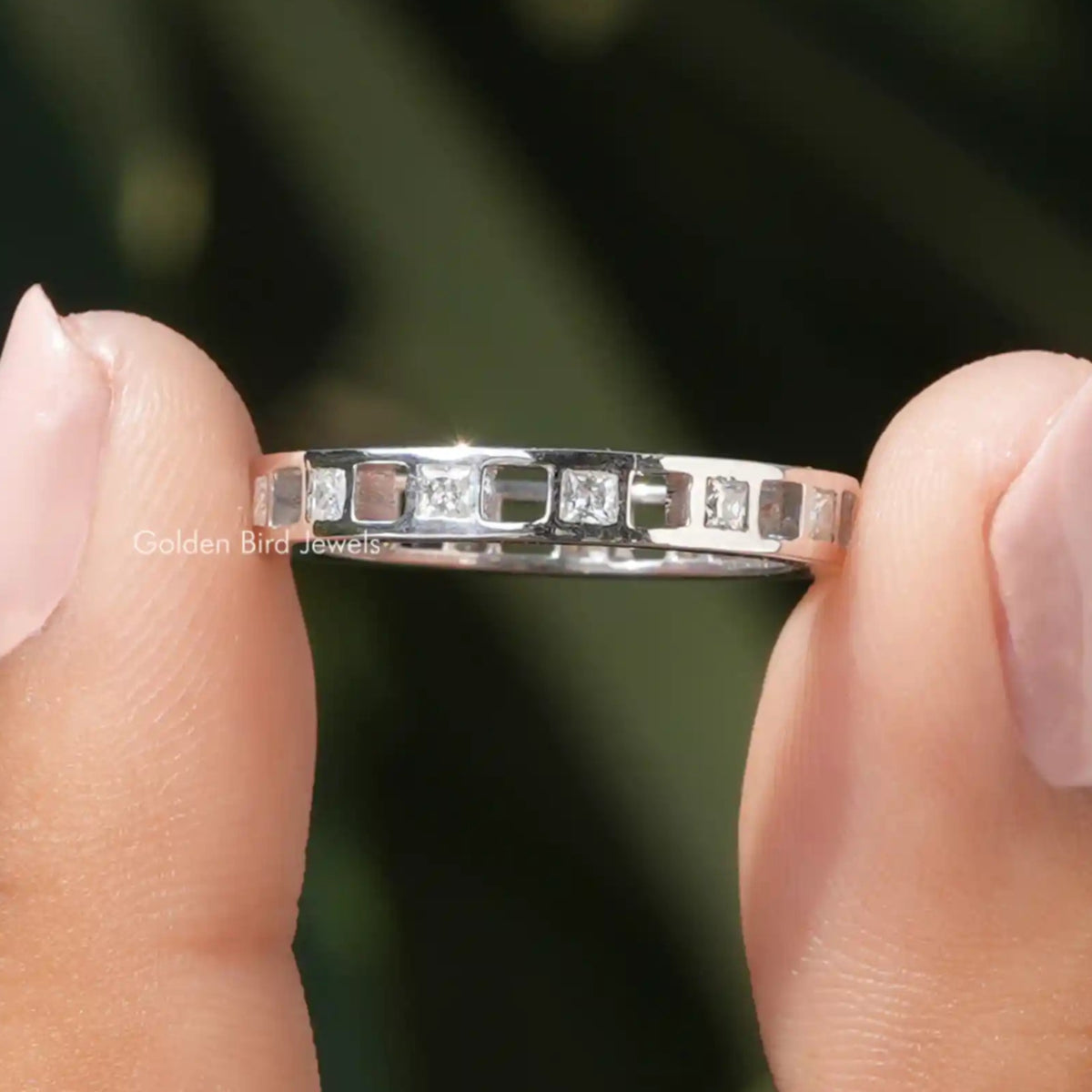 925 sterling silver eternity band with princess-cut moissanite stones, close side angle