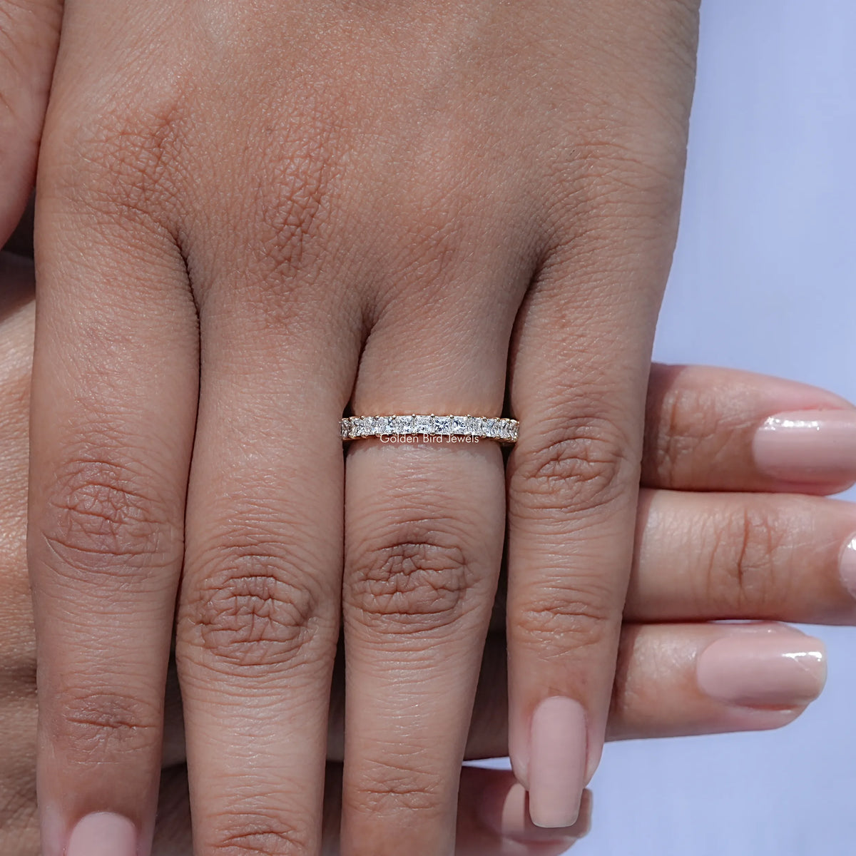 Diamond eternity band on finger, slim silver ring with square-cut stones