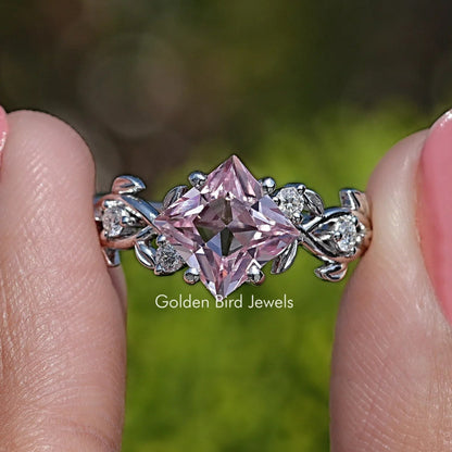 Lab gemstone engagement ring with large pink marquise center stone and diamond leaf accents