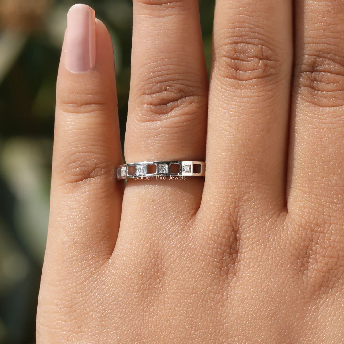 Princess-cut moissanite eternity band in 925 sterling silver, front view on fingers
