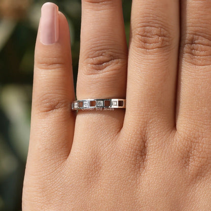 Princess-cut moissanite eternity band in 925 sterling silver, front view on fingers