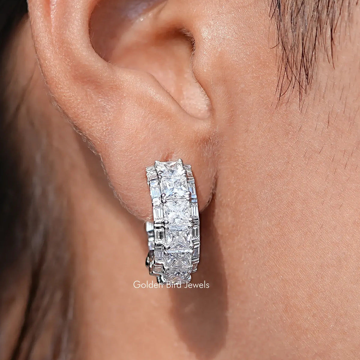 Front view of Princess Cut Moissanite Hoop Earring Set in two fingers 