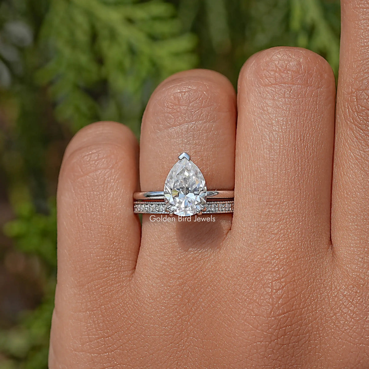 Pear moissanite ring with hidden halo and eternity band