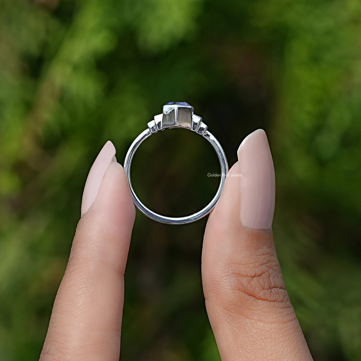 Back View of Amethyst Hexagon Cut Gemstone Ring In two fingers