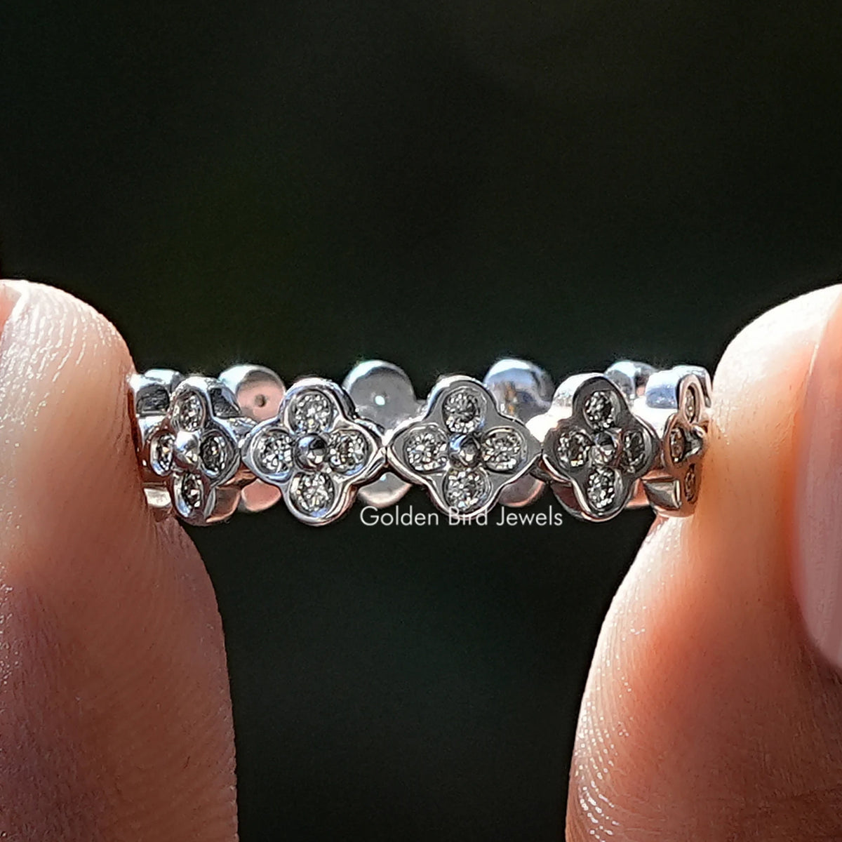Clover wedding band with round diamonds in a repeating flower pattern