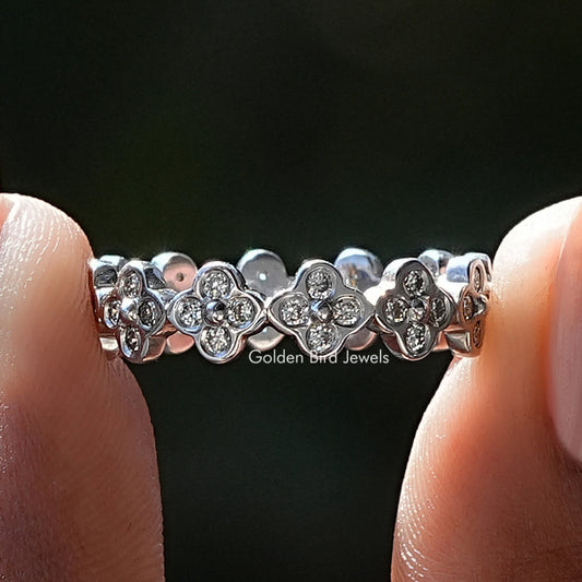 Clover wedding band with round diamonds in a repeating flower pattern