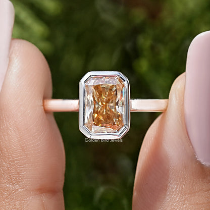 Bezel-set square radiant-cut stone on rose-gold solitaire ring
