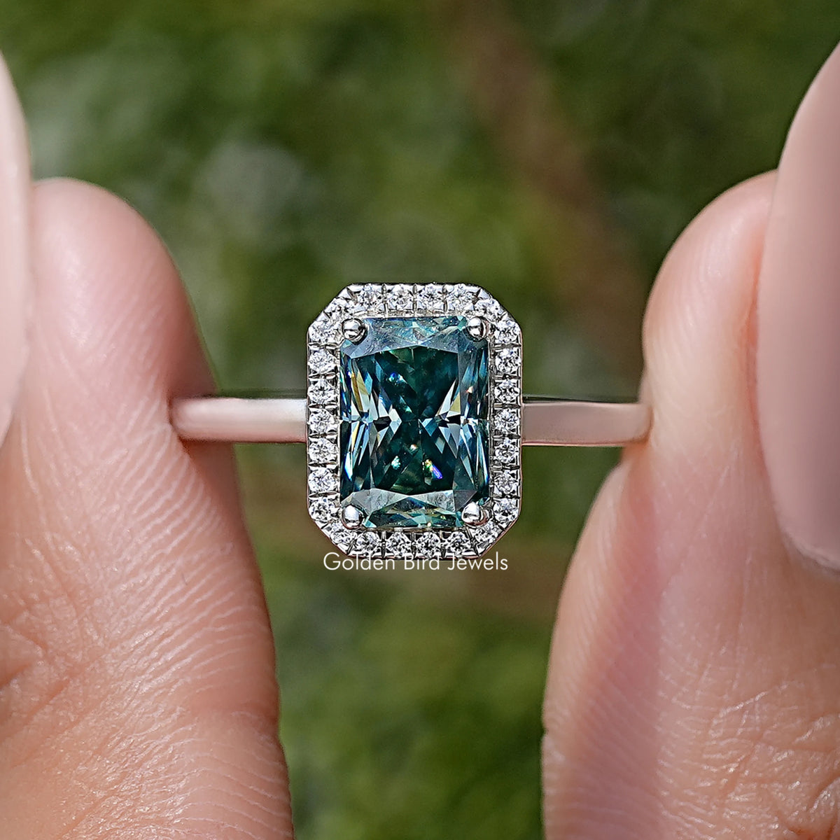 Sterling silver halo engagement ring with emerald-cut blue moissanite center stone
