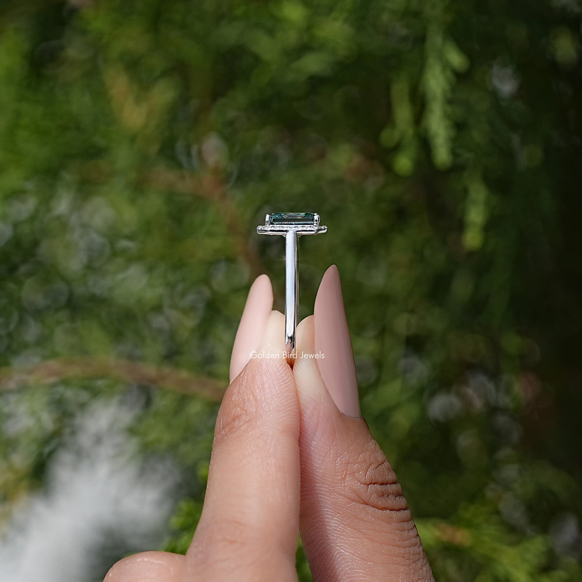 Sterling silver ring with emerald-cut blue moissanite top prongs detail
