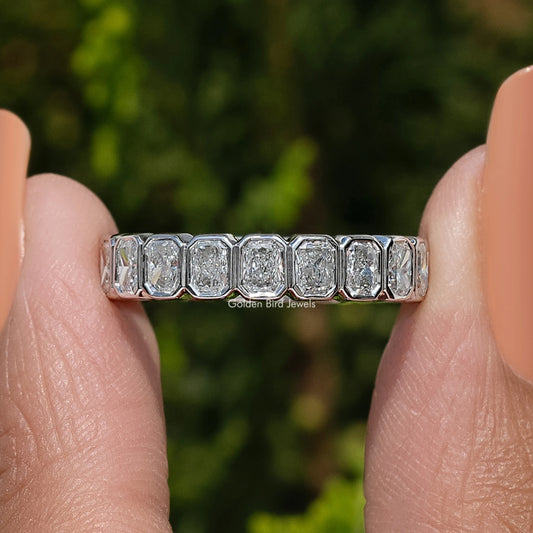 Silver eternity band ring with multiple bezel-set square-cut stones, side view