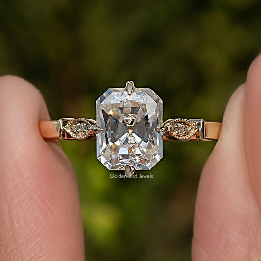 Moissanite engagement ring close-up with radiant-cut center and ornate side settings