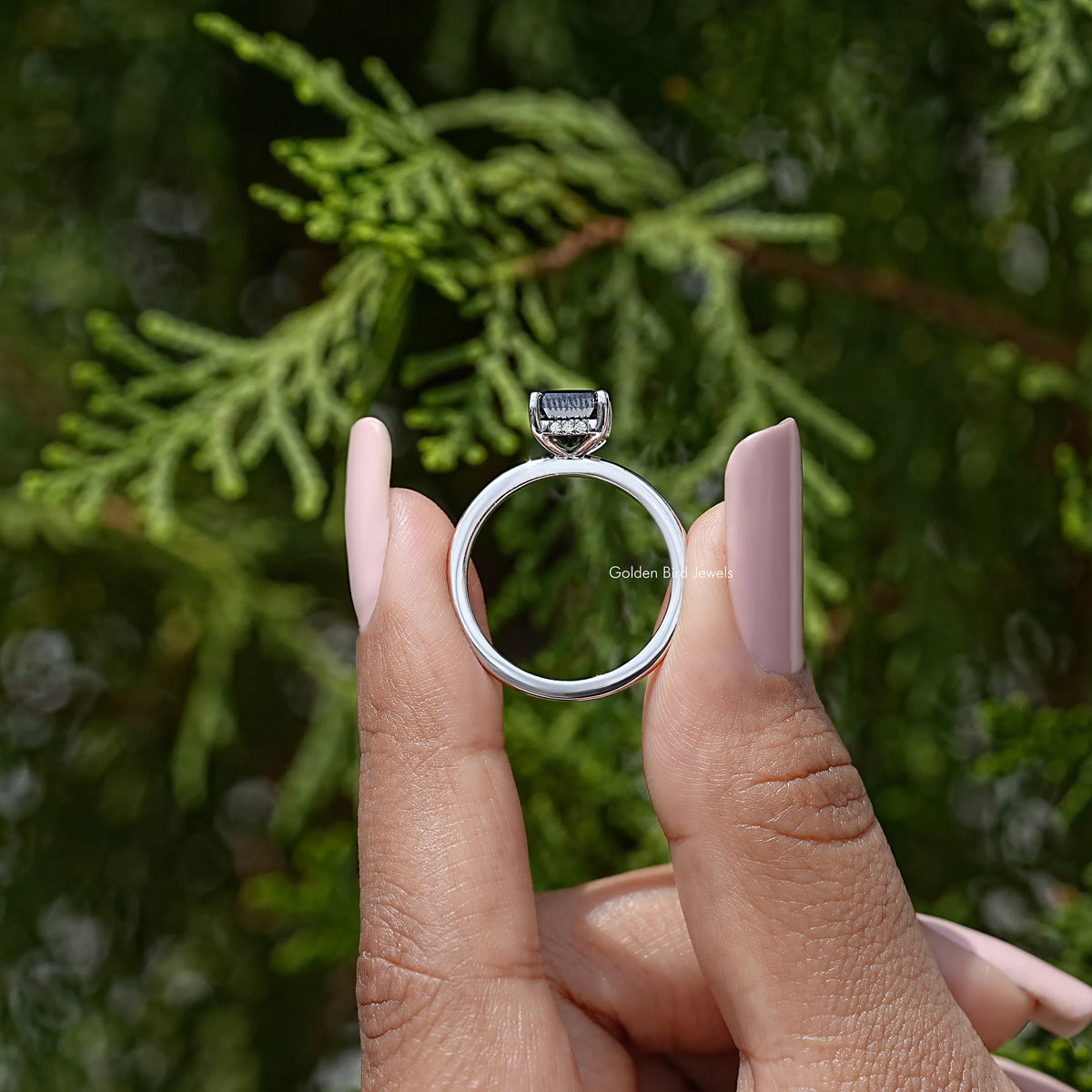 Silver ring side view with square black radiant-cut stone and hidden halo band