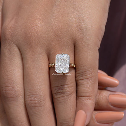 Engagement ring with large rectangular-cut center stone and gold-toned side accents