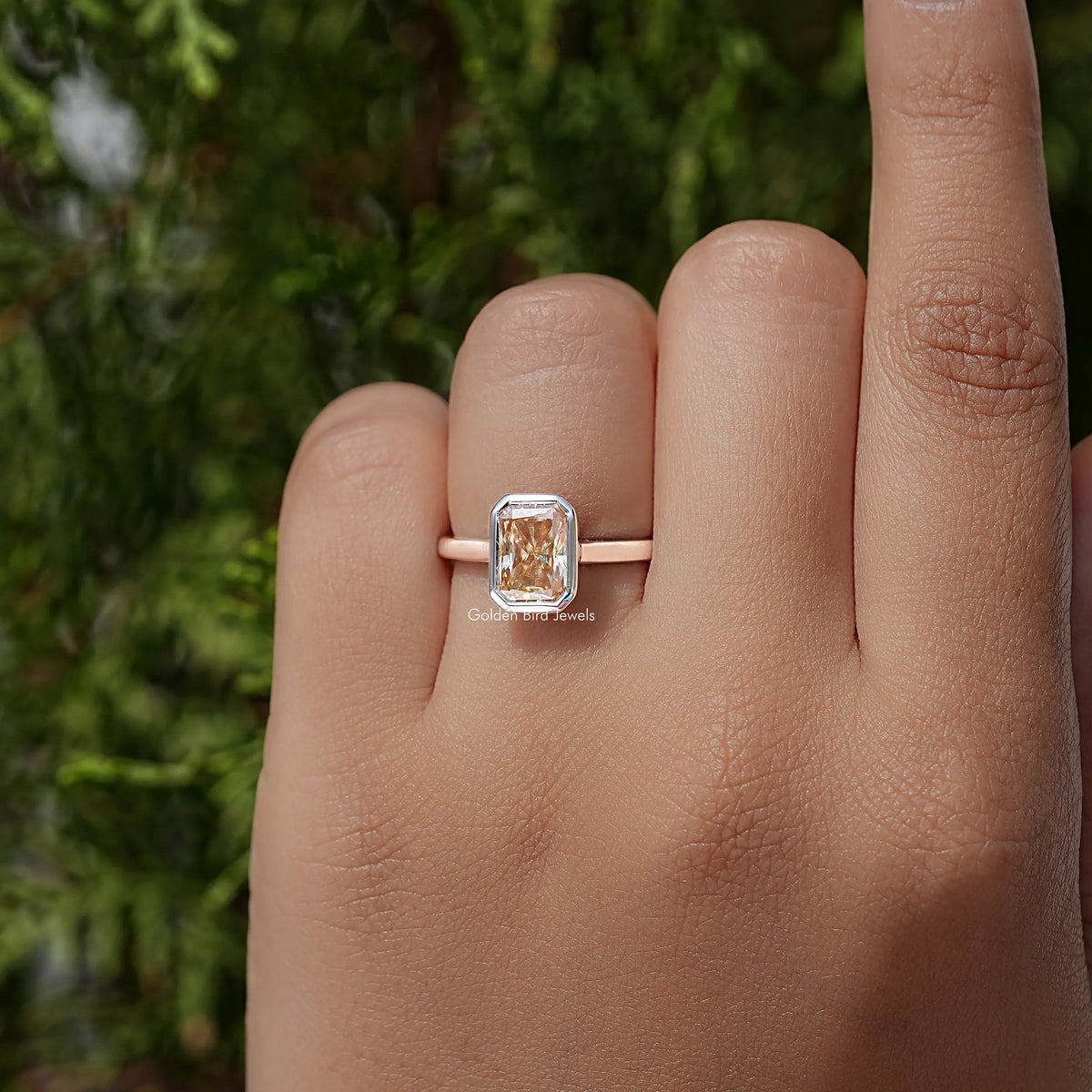 Radiant-cut solitaire ring with bezel-set square stone on rose-gold band