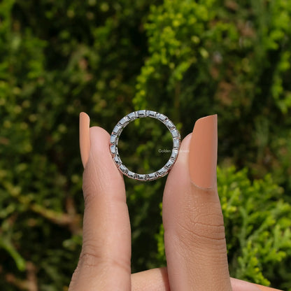 Silver eternity band ring with square-cut stones around the band edge